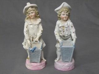 A pair of Victorian porcelain spill vases decorated boy and girl with basket 8"