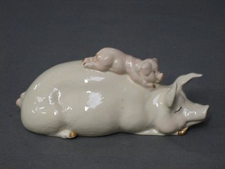 A Beswick figure of a reclining Sow with piglet, base marked Beswick 103, 6"