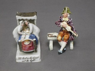 A 19th Century fairing "Last Into Bed Puts out the Light" (slight chip to bottom right hand corner), together with a porcelain figure of a seated gentleman playing a guitar 4" (f and r)