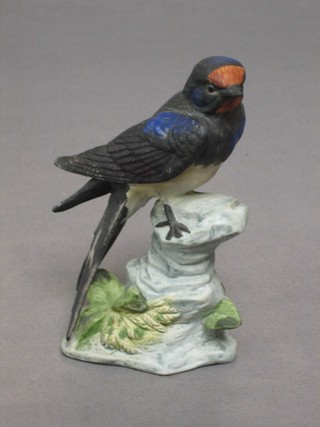 A Continental biscuit porcelain figure of a seated swallow 5 1/2"