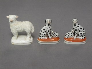 A 19th Century porcelain figure of a standing lamb, raised on an oval base 3" and 2 small reproduction Staffordshire style figures of seated Dalmatians (3)