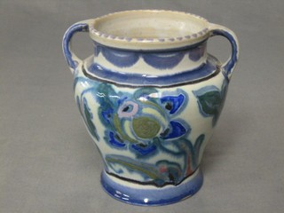 A circular twin handled Collard Honiton vase with blue floral decoration (base chipped) 6"
