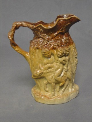 A 19th Century brown treacle glazed  jug decorated bacchanalian figures 9", (the base with slight chip)