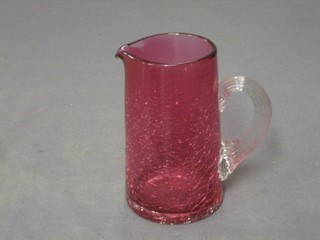 A cranberry crackle glass jug with clear glass handle 5"