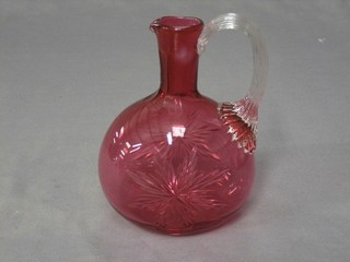A cranberry glass ewer with clear glass handle 6"