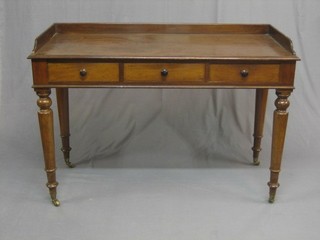 A Victorian mahogany dressing table with three-quarter gallery fitted 3 short drawers, raised on turned supports ending in brass caps and castors 49"