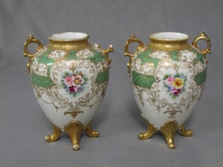 A pair of Noritake porcelain twin handled vases with green and gilt banding and floral decoration (1 handle f) 7"
