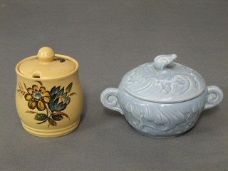 A circular blue glazed Sylvac preserve jar and cover, base marked 1699 and a brown glazed preserve jar and cover with floral decoration base marked 3209