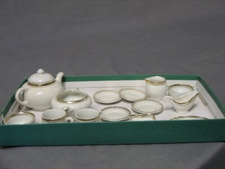 A 19th/20th Century dolls 14 piece tea/dinner service comprising twin handled soup tureen, 4 plates, circular sugar bowl, jug (f), sauce boat (f), oval meat plate, square dish (chipped), 2 mugs (1 cracked) and a sugar bowl