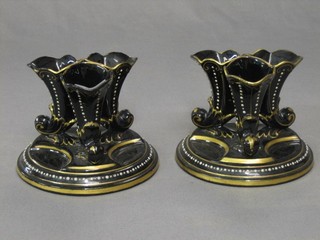 A pair of Victorian jet ware cornucopia vases, raised on circular bases 5"