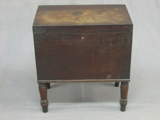 A Georgian mahogany cellarette with hinged lid the interior fitted 8 apertures, raised on turned supports 20"