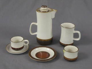 A 35 piece Denby white and brown glazed pottery coffee/dinner service comprising 2 oval dinner plates 10", 9 side plates 6 1/2", coffee pot, milk jug 4", cream jug 3", 9 coffee cups and 9 saucers, 2 sugar bowls