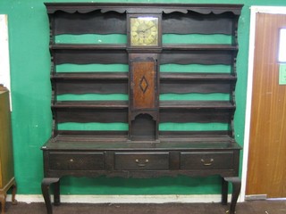 An 18th/19th Century oak House Keeper's dresser, the upper section with moulded cornice and fitted 3 shelves, the centre section incorporating a single fusee clock, the 9 1/2" square brass dial with spandrels marked Blencorve Churchill, the base fitted 3 long drawers and raised on hobnail supports 72"