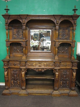 A handsome Victorian Continental carved walnut sideboard the raised back carved lion masks and with bevelled plate panel to the centre flanked by a pair of niches, the base fitted 1 long drawer flanked by 2 short drawers and with niche to the centre flanked by a pair of heavily carved panelled doors supported by mythical figures 73"