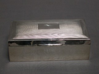 A silver cigarette box with hinged lid, Birmingham 1925 (marks rubbed) 6 1/2"