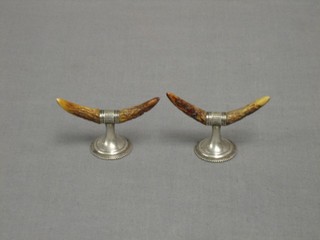 A pair of silver plated and horn mounted knife rests