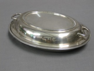 An oval silver entree dish and cover with bead work border, Sheffield 1933, 27 ozs