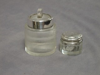 A circular cut glass salts jar with silver rim 2" and a cut glass dressing table jar with silver lid 1"