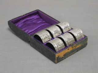 A set of 6 engraved silver plated napkin rings, cased