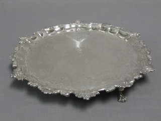 A George III silver salver, the bracketed border cast fruit with engraved panel and armorial decoration to the centre, raised on 3 hoof feet, London 1795, 27 ozs