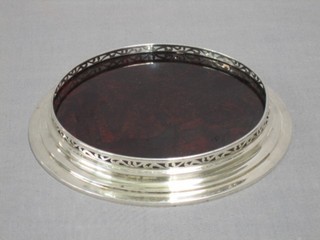 A circular pierced silver teapot stand with mahogany base London 1937, 7 1/2"