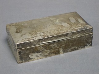 A rectangular silver cigarette box with hinged lid, London 1905, marks rubbed, together with 2 silver bottle pourers, a small bottle bung and a napkin ring