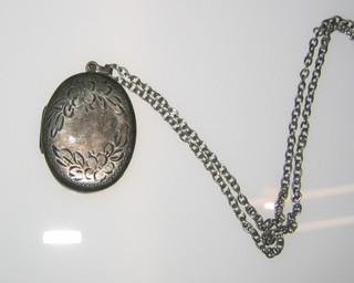 An engraved oval silver locket hung on a silver chain