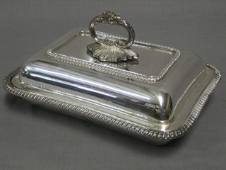 A rectangular silver plated entree dish and cover with gadrooned borders