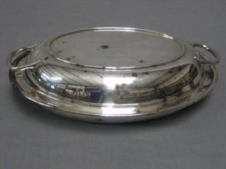 An oval silver plated twin handled entree dish and cover