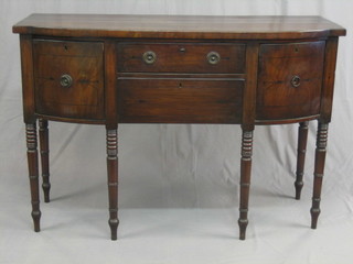 A Georgian mahogany bow front sideboard with 2 long drawers flanked by cupboards, raised on ring turned supports 54"
