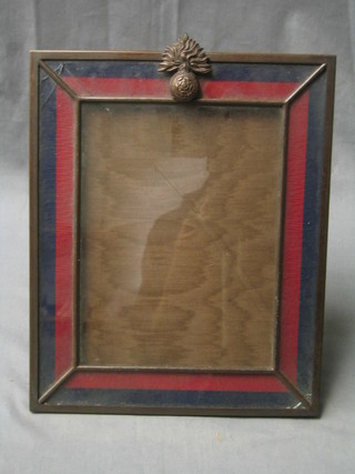 A bronze eagle frame, surmounted by the crest of the Royal Fusiliers with colours to border by Vickery (glass f)