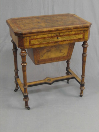 A Victorian figured walnut and crossbanded lozenge shaped games/work table with flap top, the base fitted a drawer and deep basket, raised on turned supports 26"