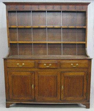 An 18th Century Welsh dresser, the raised back with moulded cornice and iron hooks, fitted 2 shelves, the base fitted 3 drawers above a double cupboard, raised on bracket feet 61"