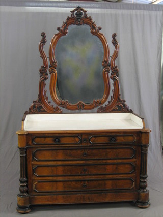 A handsome 19th Century Continental walnut wash stand with shaped plate mirror, white marble top and three quarter gallery, fitted 2 short and 3 long drawers with fluted columns to the sides