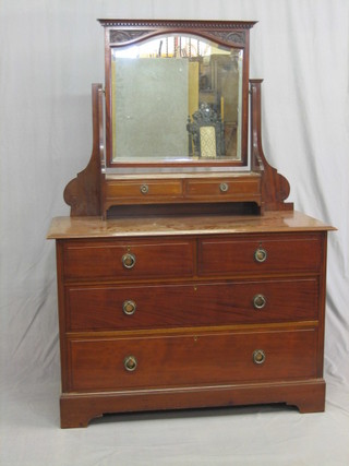 An Edwardian walnut dressing chest with mirror, the base fitted 2 glove drawers above 2 short and 2 long drawers, raised on bracket feet 48"