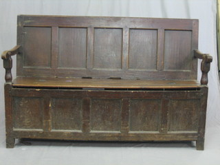 An 18th/19th Century oak settle of panelled construction from old timber 63"