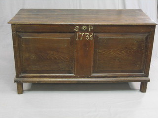 An 18th Century oak coffer of panelled and plank construction with hinged lid and stud work to the front, marked 1736 52"