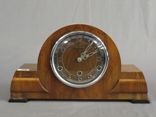 A 1930's Westminster chiming mantel clock with silvered dial and Arabic numerals contained in an arched walnut case