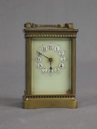 A 19th Century French 8 day carriage clock with porcelain dial and Arabic numerals (chip to the dial)
