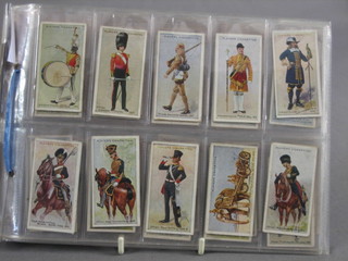 A set of John Players Regimental Uniforms 1914 and a set of John Players Military Headdress 1931 cigarette cards  