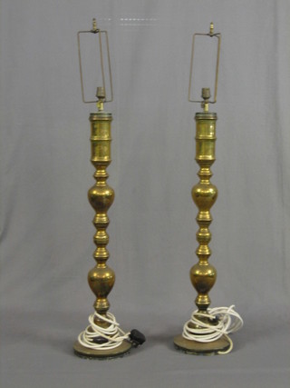 A pair of large brass table lamps in the form of candlesticks