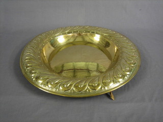 A circular embossed brass charger with gadrooned border 22"