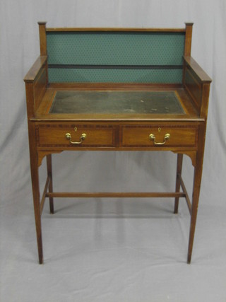 An Edwardian inlaid mahogany writing table with three-quarter gallery, fitted 2 frieze drawers with brass swan neck drop handles, raised on square tapering supports 30 1/2"