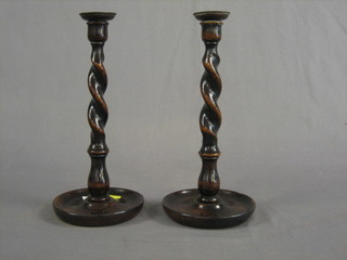 A pair of wooden spiral turned candlesticks 12"