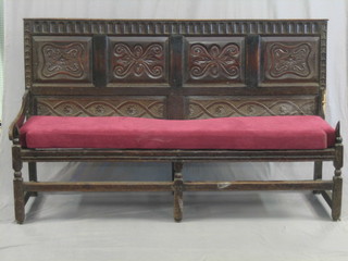 An 18th/19th Century carved oak settle with arcaded decoration, raised on turned and block supports (1 arm f) 72"