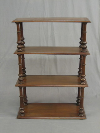 A Victorian rectangular walnut 3 tier hanging shelf raised on turned supports 34"