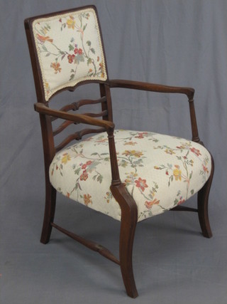 An Edwardian Georgian style walnut ladder back open arm chair with upholstered seat and back