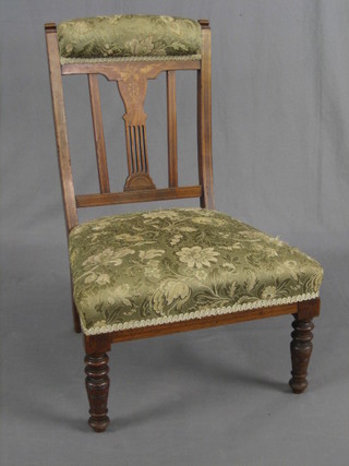 An Edwardian inlaid rosewood nursing chair, raised on turned supports