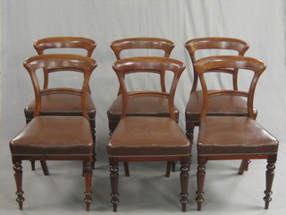 A set of 6 Victorian mahogany bar back dining chairs with plain mid rails and upholstered seats, raised on turned supports