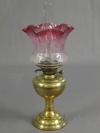 A 19th Century brass oil lamp reservoir with etched glass shade